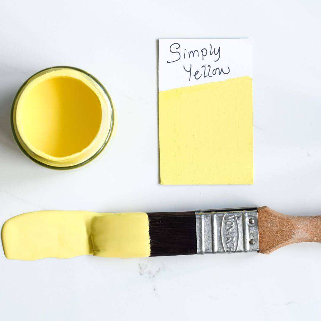 Paint brush dipped in 120ml pot of Blake & Taylor Simply Yellow Chalk Furniture Paint