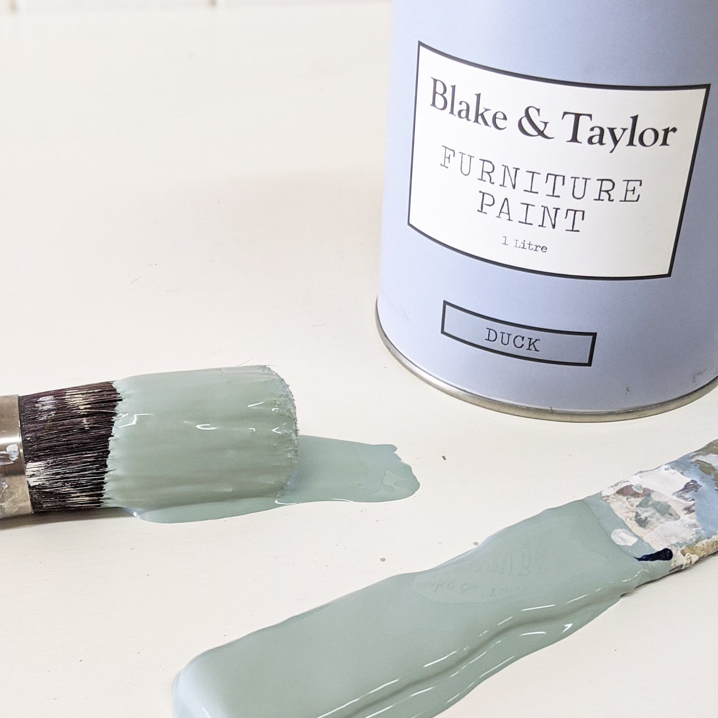 paint brush and paint stirrer dipped in Blake & Taylor Duck Chalk Furniture Paint