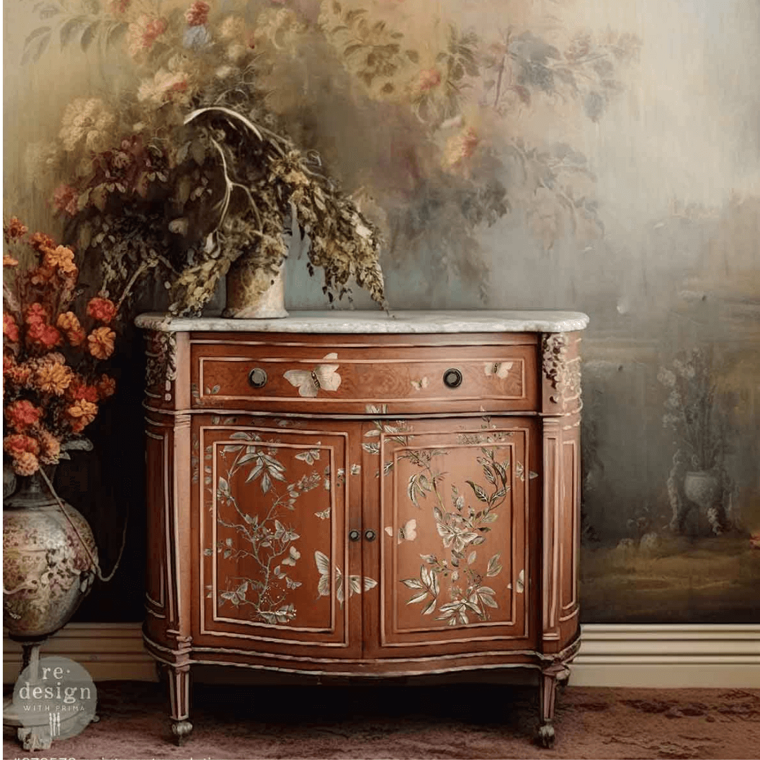 Decorative wooden cabinet with floral patterns in a room with floral wallpaper and decor.
