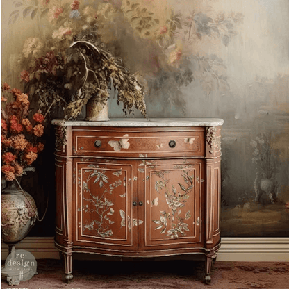 Decorative wooden cabinet with floral patterns in a room with floral wallpaper and decor.