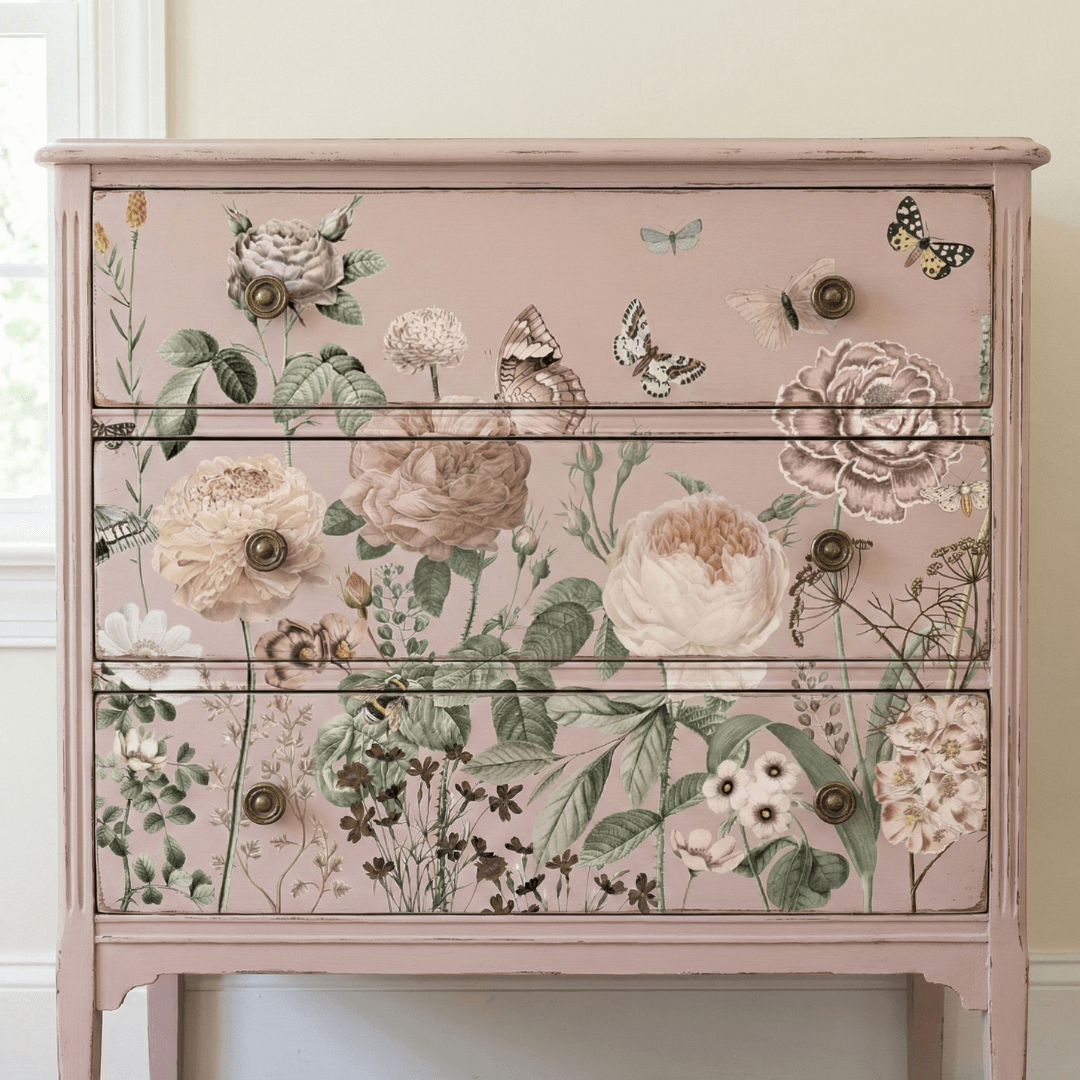Pink dresser with floral and butterfly decal on a white wall