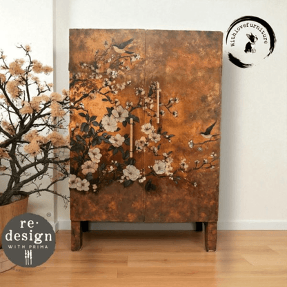 Decorative cabinet with floral and bird design in a room with a plant and white wall.