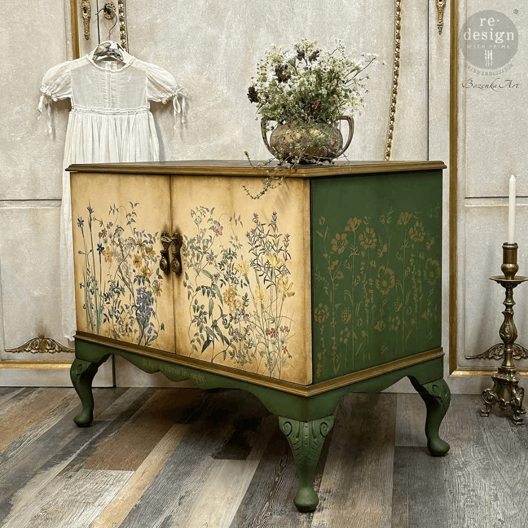 Decorative cabinet with floral patterns, white dress, and vase of flowers in a vintage room.