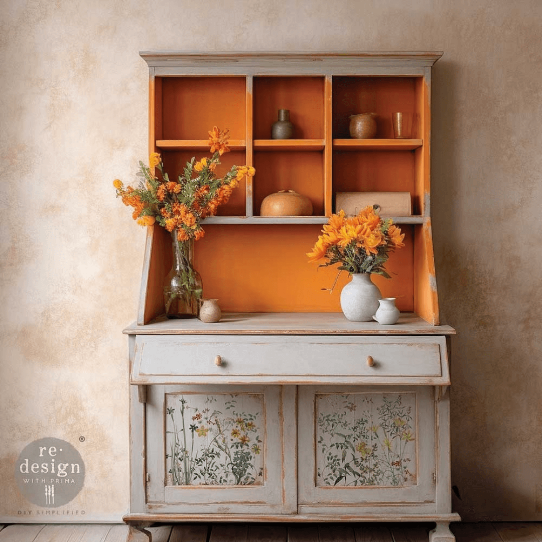 Vintage-style cabinet with floral design on doors against a beige wall.