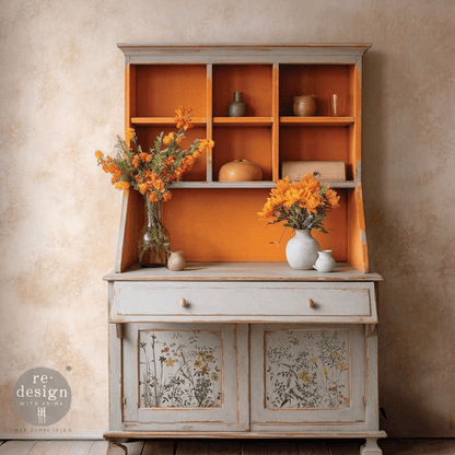 Vintage-style cabinet with floral design on doors against a beige wall.