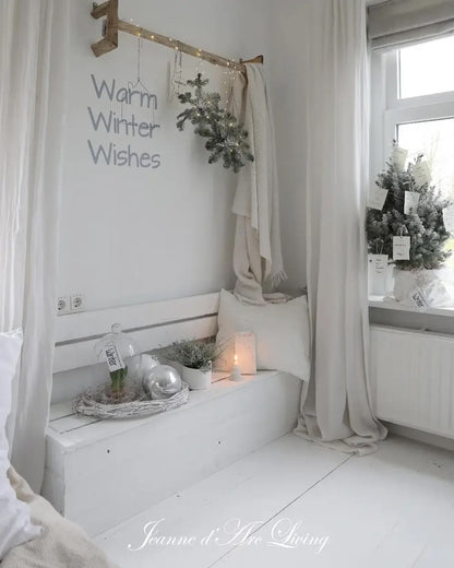Cozy bedroom with white walls, a window, and decorative elements for winter.