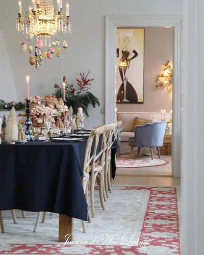 Dining room with a decorated table, chandelier, and wall art.