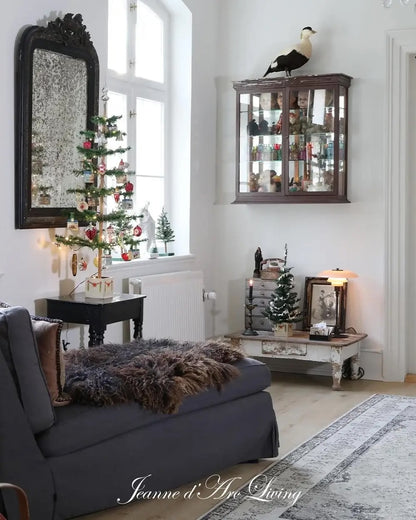 Living room with Christmas decorations, including a small tree and ornaments.