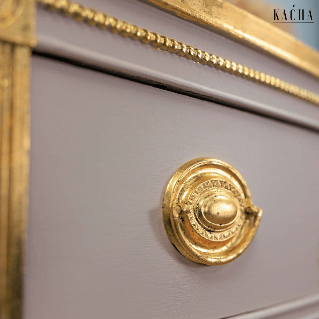 up close detail of drawer handle decorated with gold leaf
