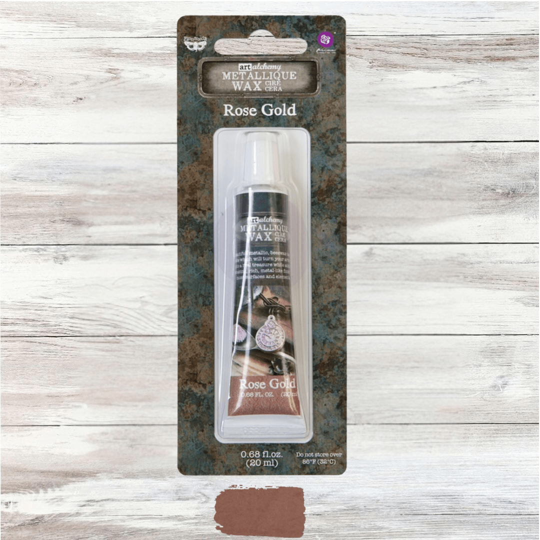20ml tube of Art Alchemy Metallique Wax in Rose Gold by Re·design with Prima, featuring a warm pink-metallic swatch.
