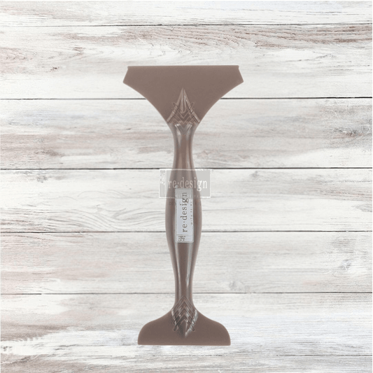 Professional double-ended tan transfer application tool by Re·design with Prima, shown against a whitewashed wood background.