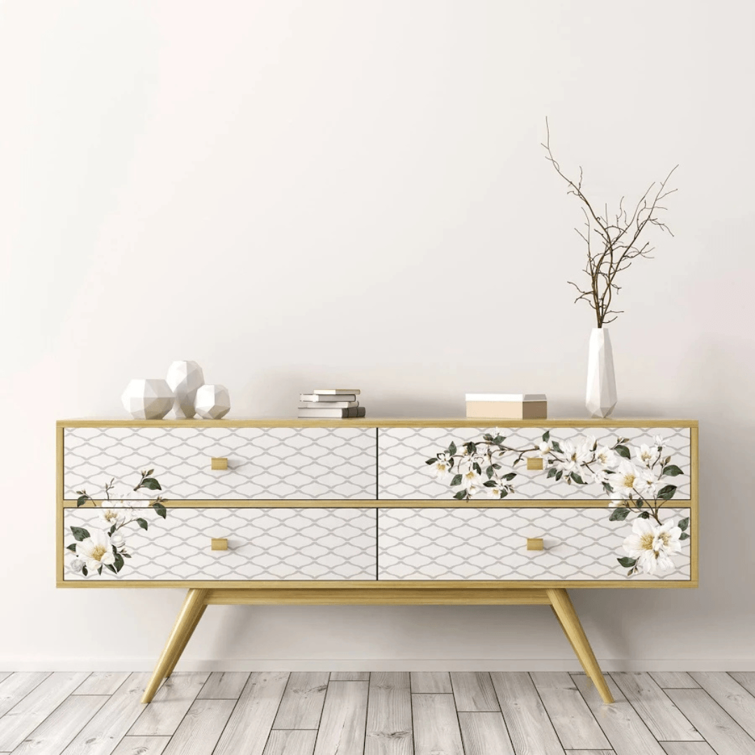 Decorative console table with floral patterns on a light wooden floor and white wall background
