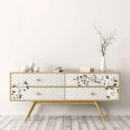 Decorative console table with floral patterns on a light wooden floor and white wall background