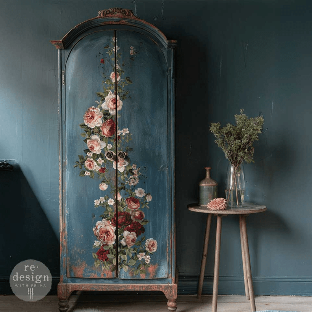 Decorative cabinet with floral design against a dark blue wall