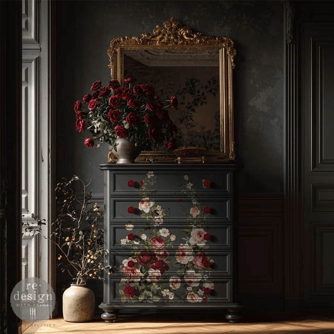 Decorative chest of drawers with floral patterns in a darkly decorated room.