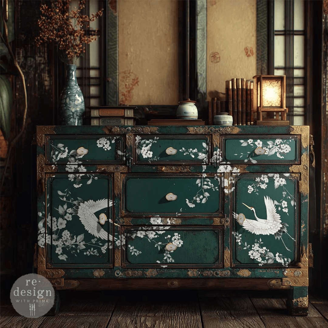 Dark green chest of drawrs decorated with Decor transfer of asian crane birds and white cherry blossom, with gold accents