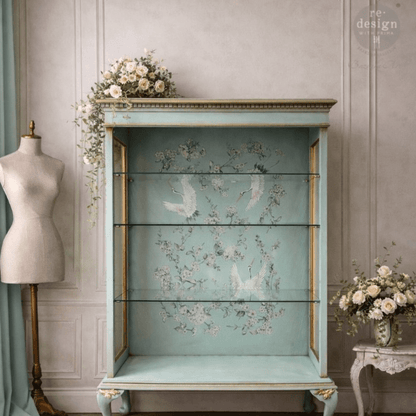 Light green cabinet decorated with Decor transfer of asian crane birds and white cherry blossom