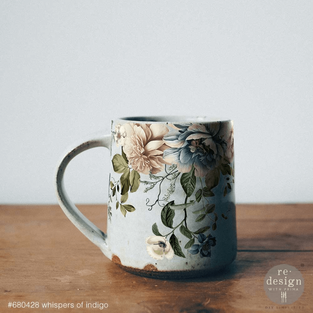 Floral-patterned mug on a wooden surface with a light gray background