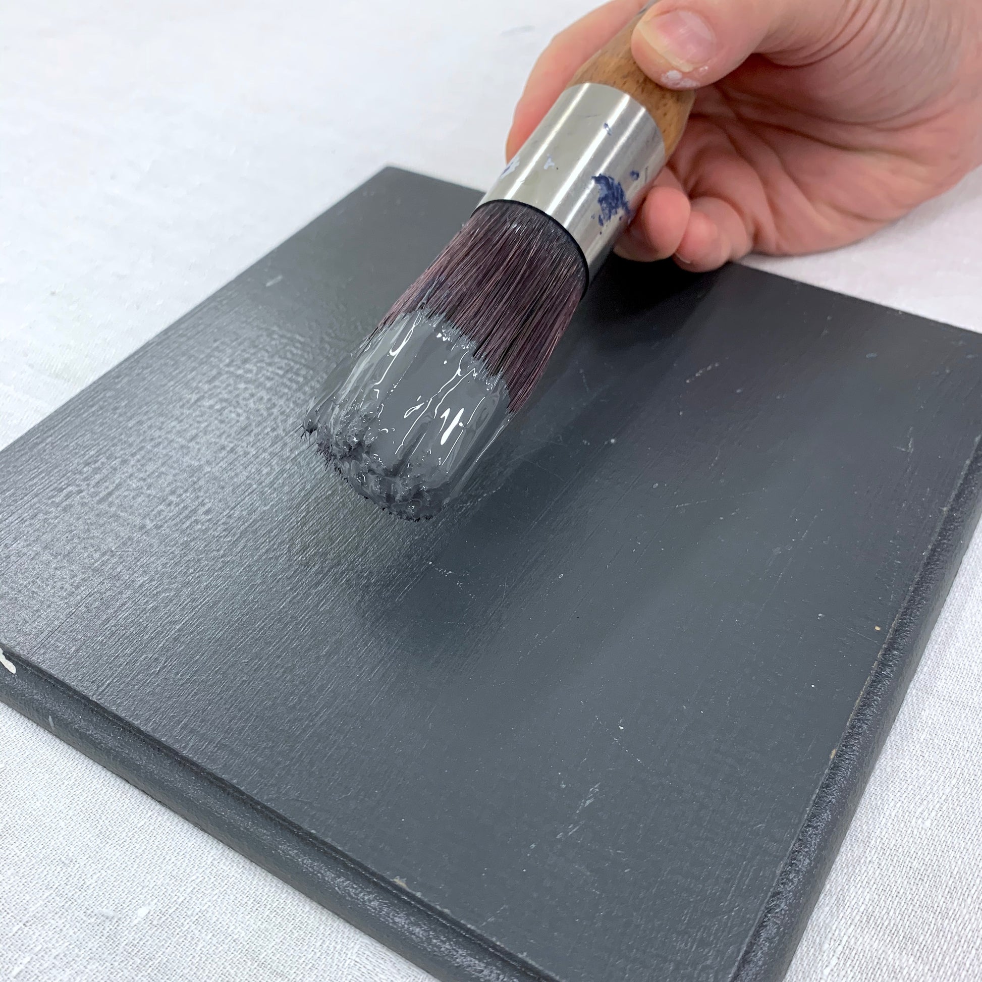 Paintbrush and Square timber swatch painted with Charcoal Blake & Taylor Chalk Furniture Paint