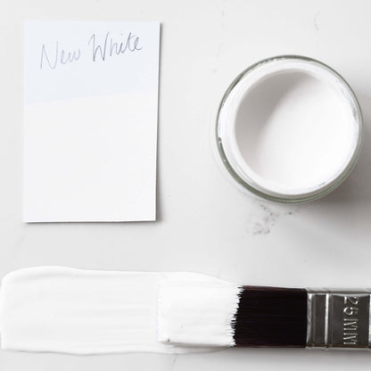 colur swatch and paintbrush dipped in 120ml pot of Blake & Taylor New White Chalk Furniture Paint