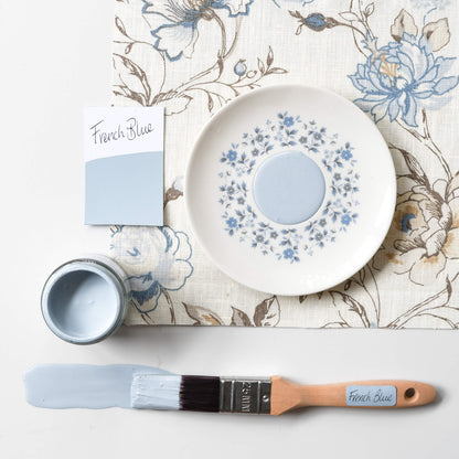 Fabric mood board with paintbrush dipped in a 120ml pot of Blake & Taylor French Blue  Chalk Furniture Paint