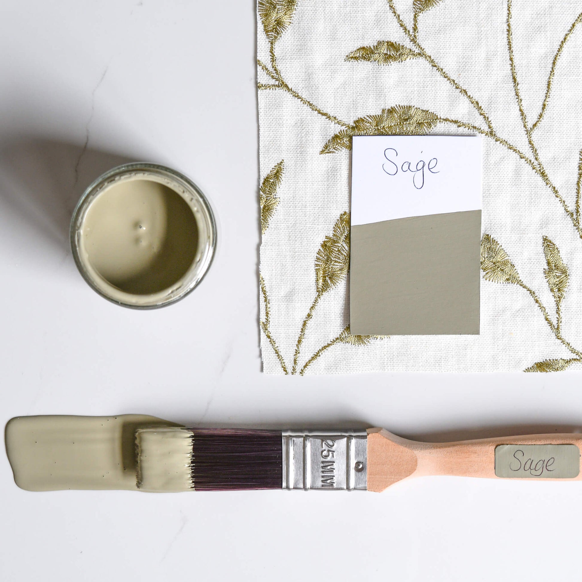 Fabric mood board with paintbrush dipped in 120ml pot of  Blake & Taylor Sage Chalk Furniture Paint
