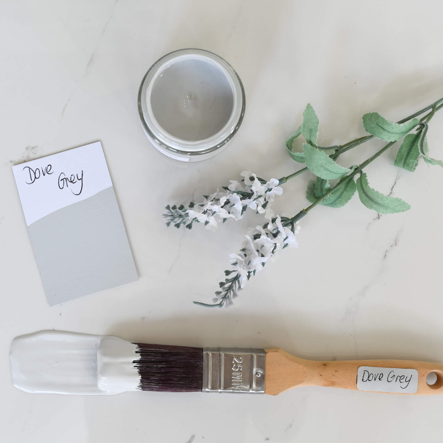 Paintbrush dipped in a 120ml pot of Blake & Taylor Dove Grey Chalk Furniture Paint