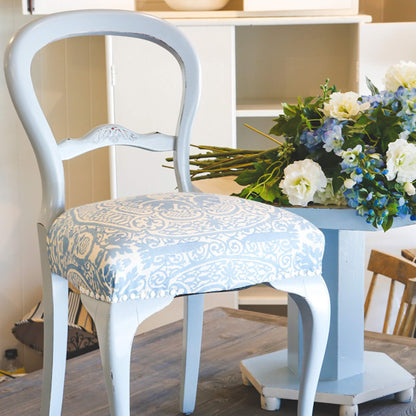 Vintage chair with blue pattern upholstery painted with Blake & Taylor French Blue Chalk Furniture Paint